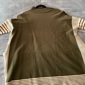 Green sweater. Opened sides. Large, high neck